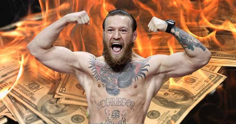 Conor McGregor in front of some cash on fire for his second fight against Poirier at UFC 257