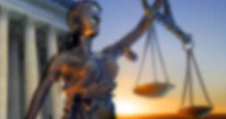 a blurry image of a statue of Lady Justice