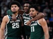 Michigan State Spartans basketball players with their arms around each other