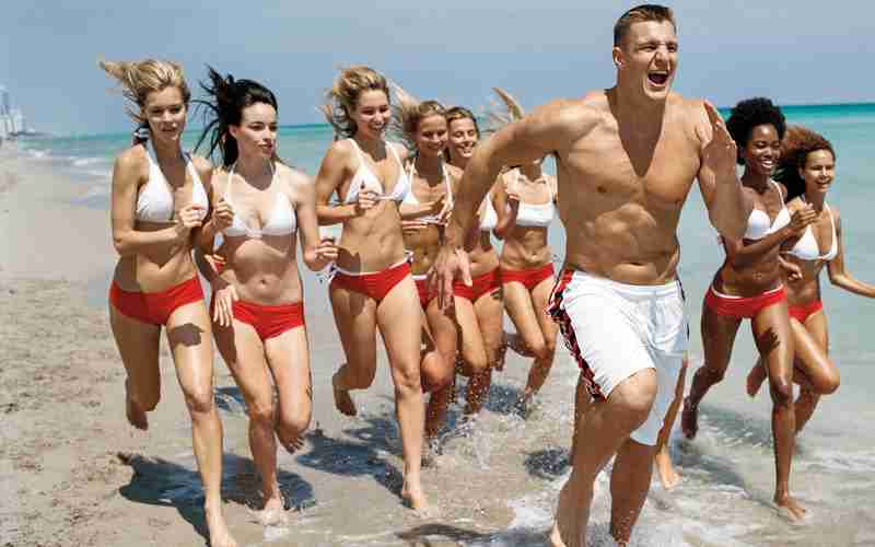 Rob Gronkowski Tampa Bay Buccaneers Tight End jogging with ladies having fun on the beach