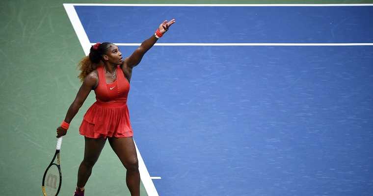 Serena Williams about to hit a serve at the US Open