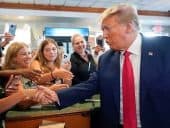 Donald Trump shaking hands with supporters