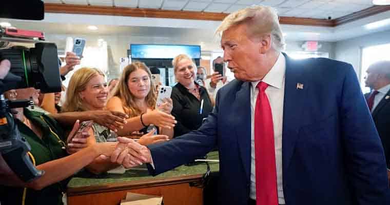 Donald Trump shaking hands with supporters