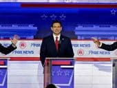 GOP Debate Stage with three candidates arguing