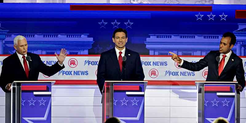 GOP Debate Stage with three candidates arguing