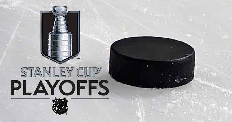 Stanley Cup Playoffs logo next to a hockey puck laying on the ice