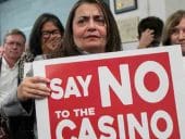 Protestors holding signs agains Freedom Plaza casino